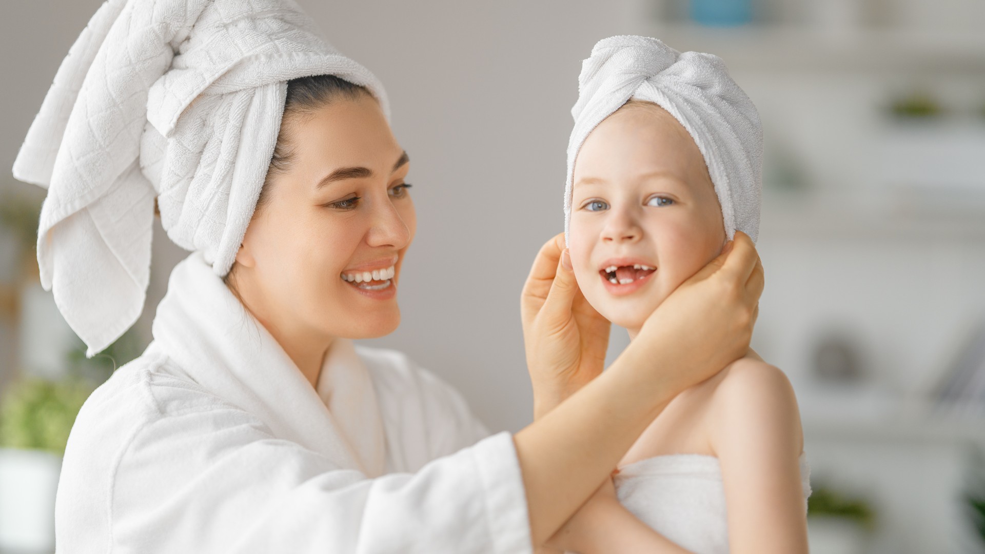 Mother and daughter sectioning hair for a careful at-home lice prevention check