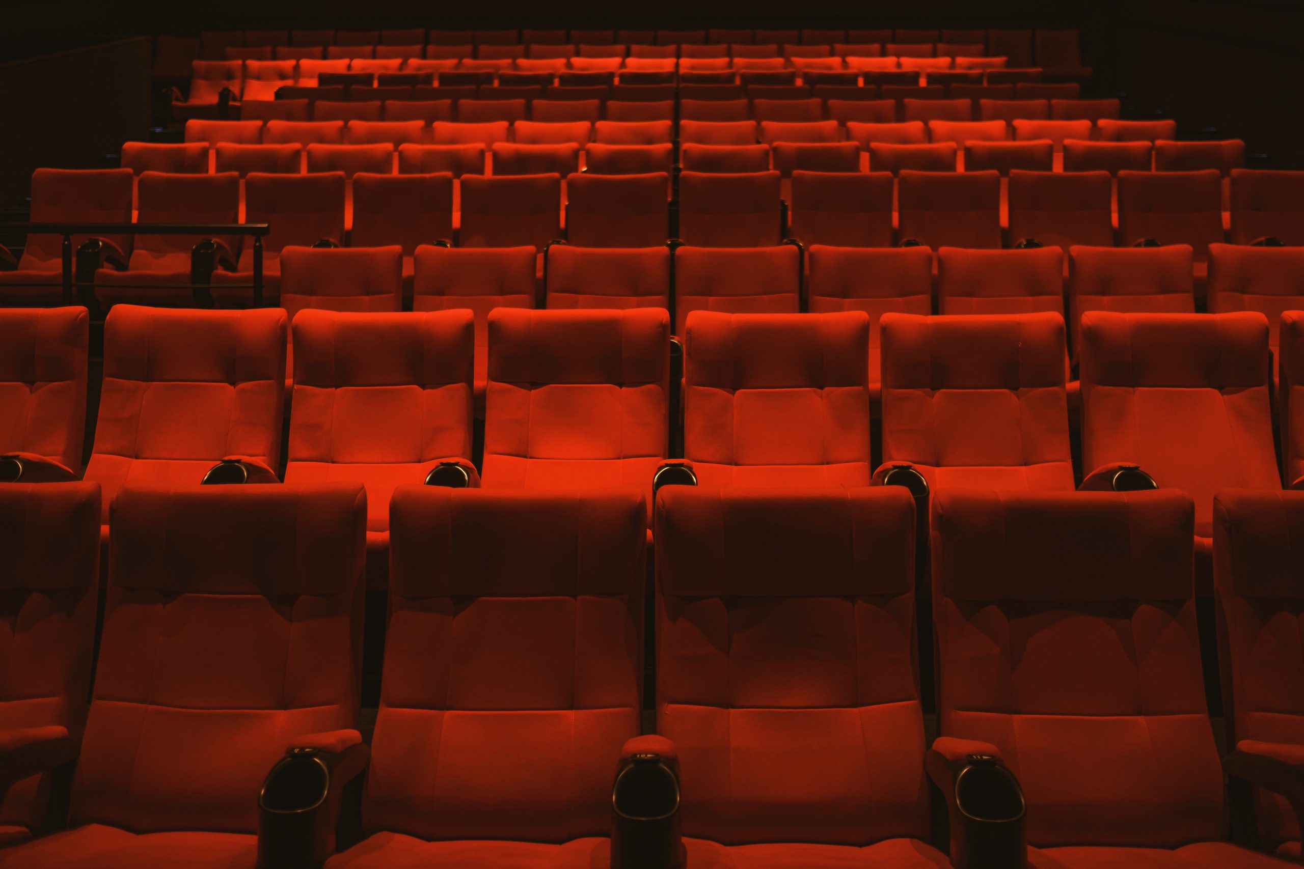 Rows of empty movie theater seats for a lice-transmission article.