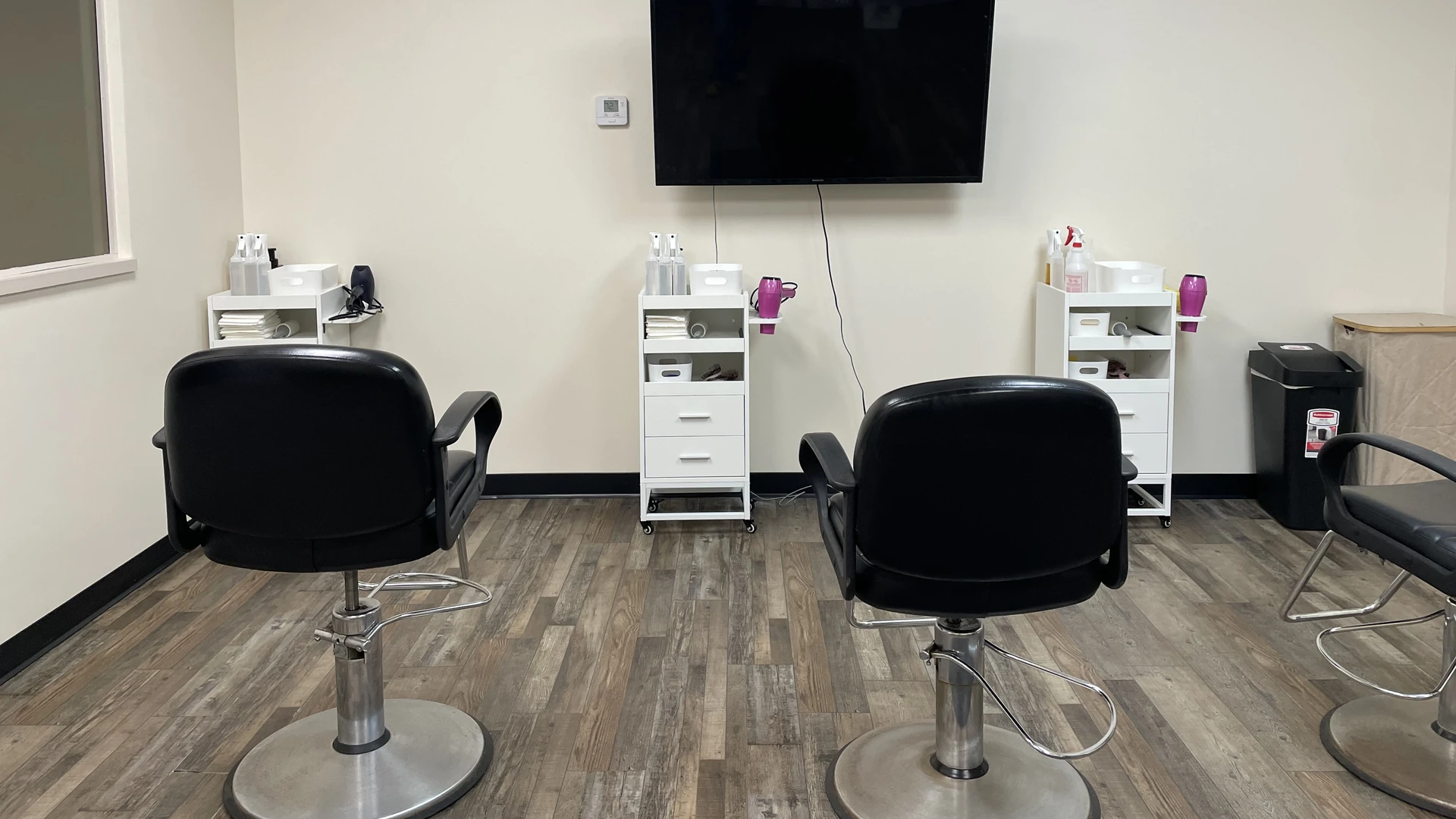 Two treatment chairs and supply carts in the Lice Lifters of Omaha treatment room.